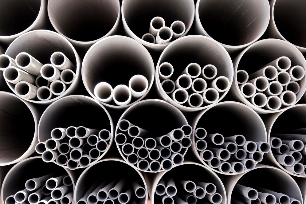 Organized bundles of PVC pipes used for plumbing and industrial applications.